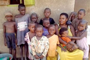 0 PAY The Ugandan woman Mariam Nabatanzi sits in front of the house with twelve of her children in Kasawo