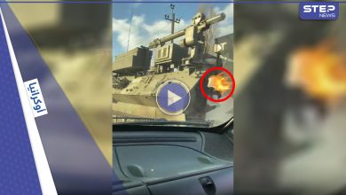 بالفيديو|| فتاة أوكرانية تلقي قنبلة "مولوتوف" حارقة على حاملة صواريخ روسية تسير على الطريق