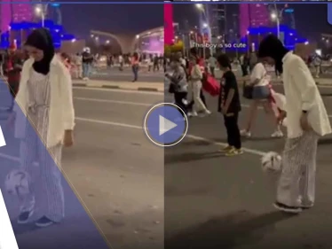 شاهد|| فتاة محجبة بأحد شوارع قطر تخطف الأضواء وتلقن شاباً درساً بفنون كرة القدم